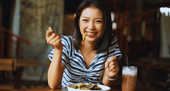 Invisible Braces 7 Woman Enjoying Her Food And Smiling - kohe Dental